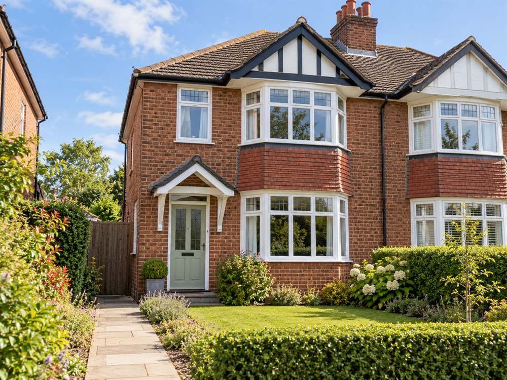 Red-brick UK semi-detached house with bay windows